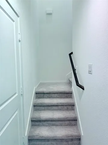 a view of staircase with white walls