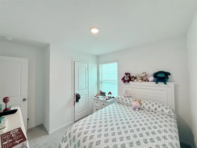 a bedroom with a bed and a dresser in it