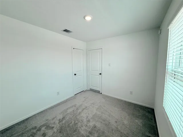 an empty room with a empty space and windows