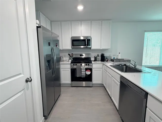 a kitchen with a refrigerator and a sink