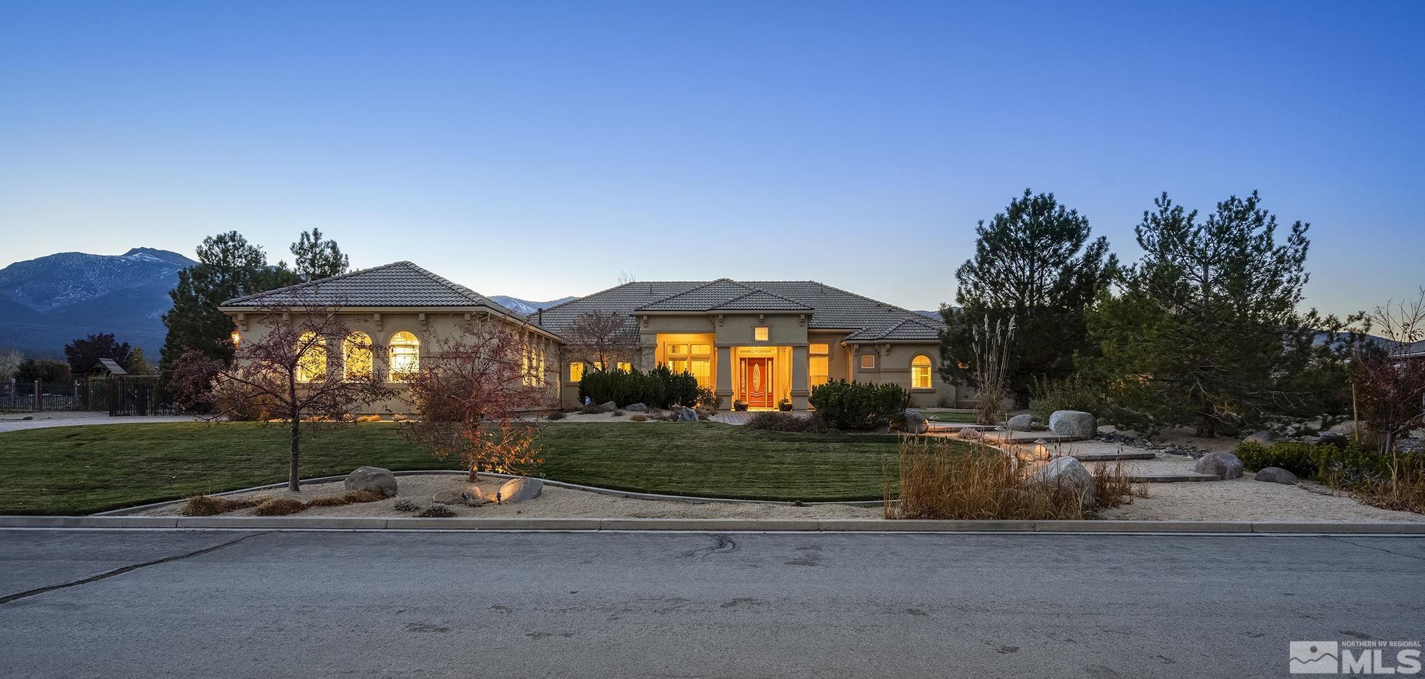 a view of a house with a yard and table under an umbrella