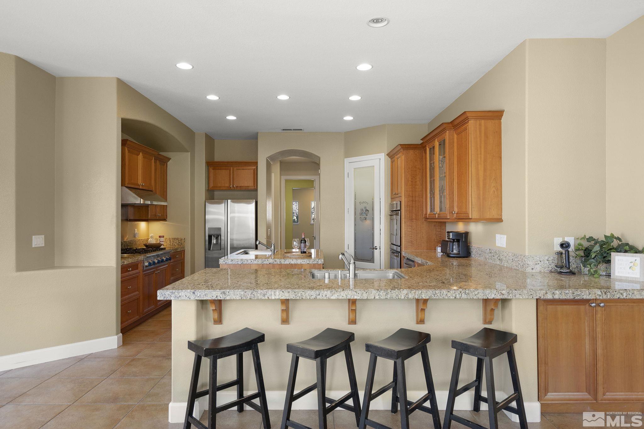 15300 Redmond Loop Reno, NV 89511 - Photo 13 of 38 a dining hall with stainless steel appliances granite countertop a dining table and chairs