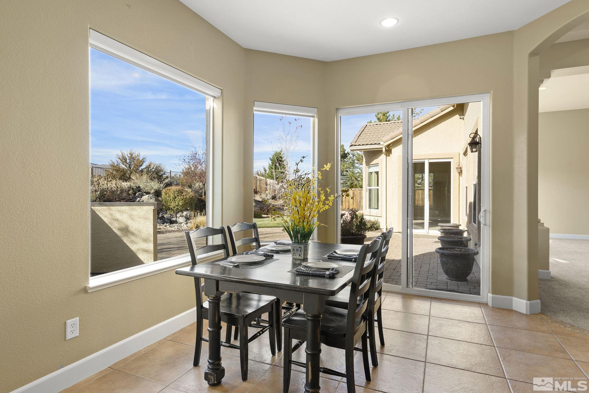 15300 Redmond Loop Reno, NV 89511 - Photo 15 of 38 a view of a dining room with furniture and a potted plant