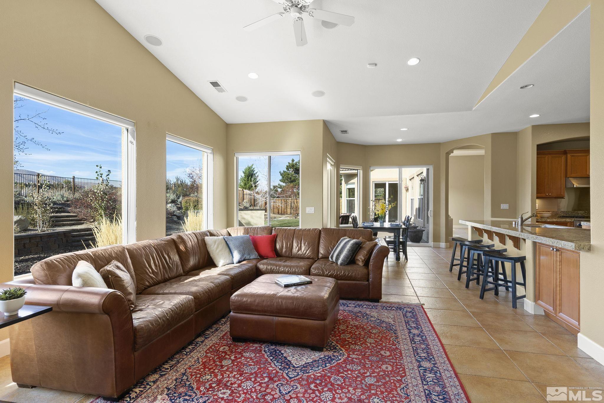 15300 Redmond Loop Reno, NV 89511 - Photo 16 of 38 a living room with furniture ceiling fan and a rug