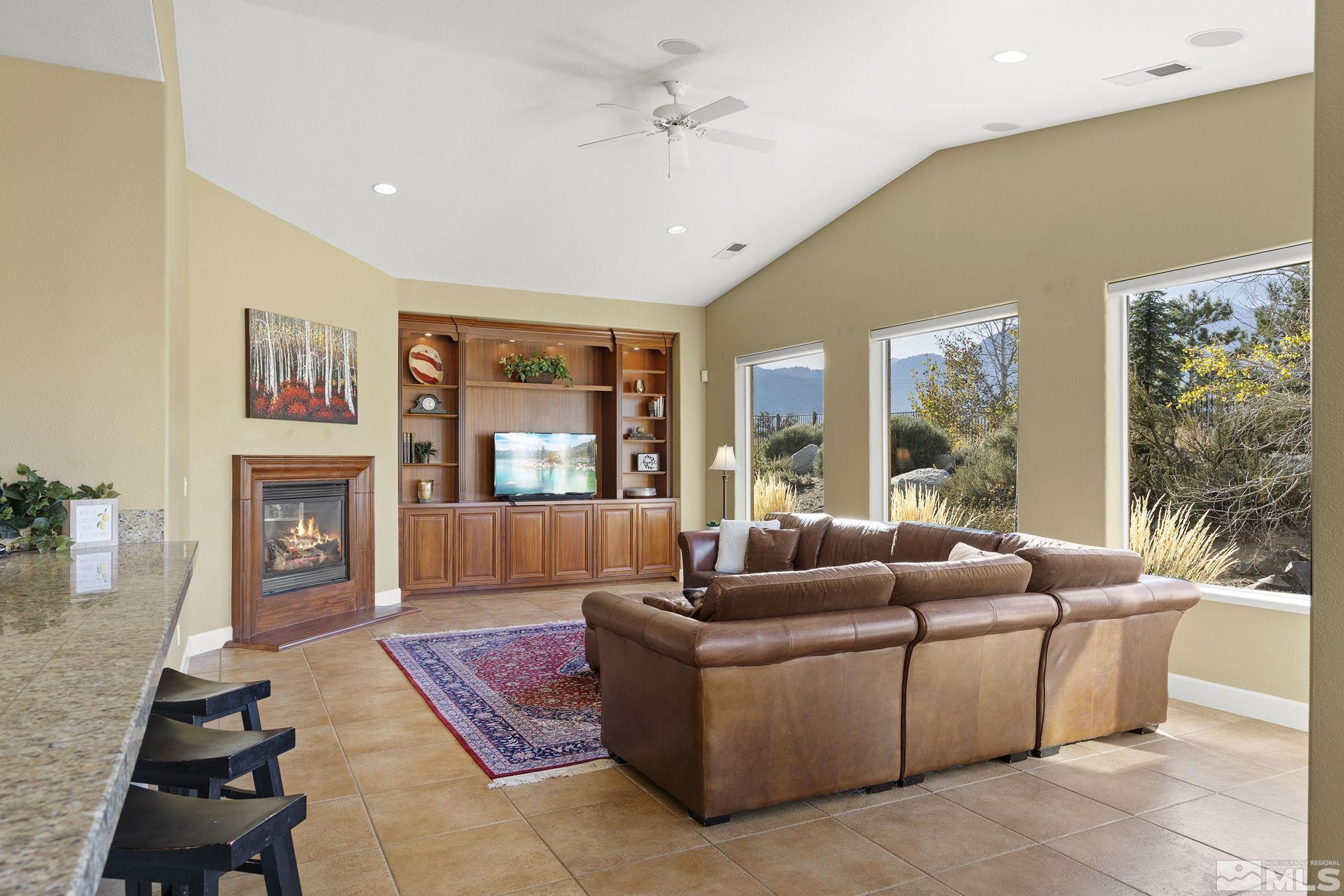 15300 Redmond Loop Reno, NV 89511 - Photo 18 of 38 a living room with furniture fireplace and a large window