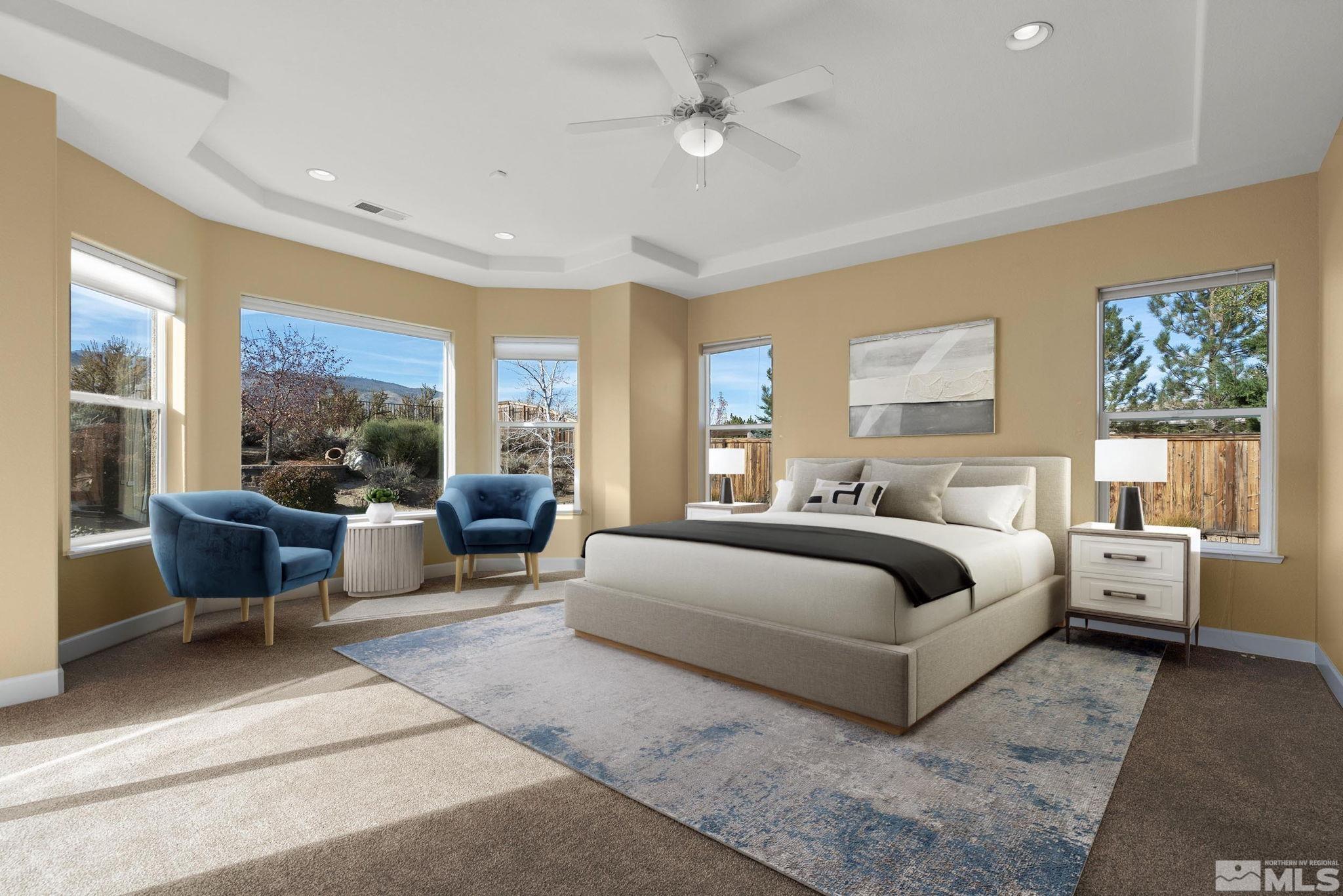 15300 Redmond Loop Reno, NV 89511 - Photo 19 of 38 a spacious bedroom with a large bed couch and windows