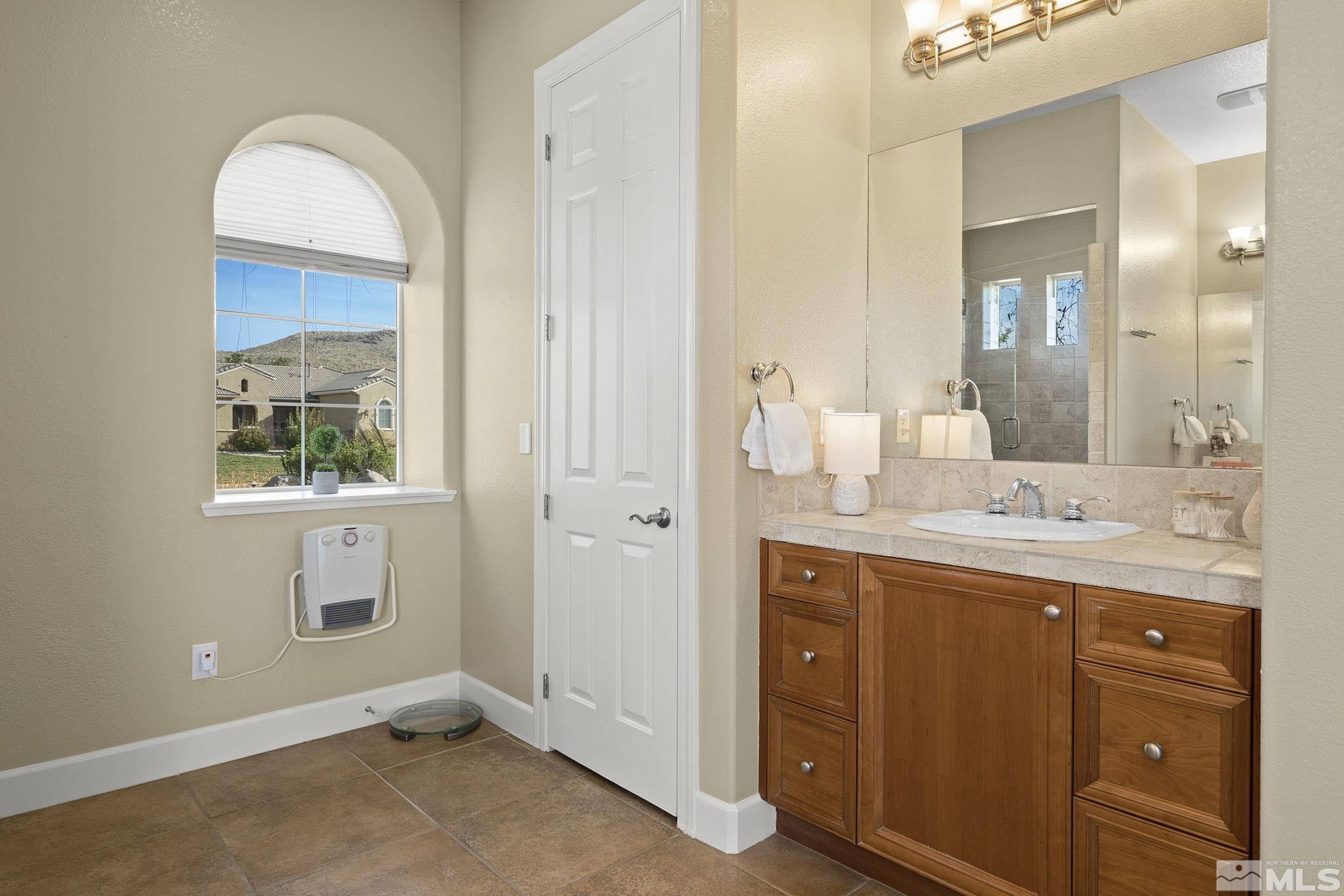 15300 Redmond Loop Reno, NV 89511 - Photo 20 of 38 a bathroom with a sink and a mirror