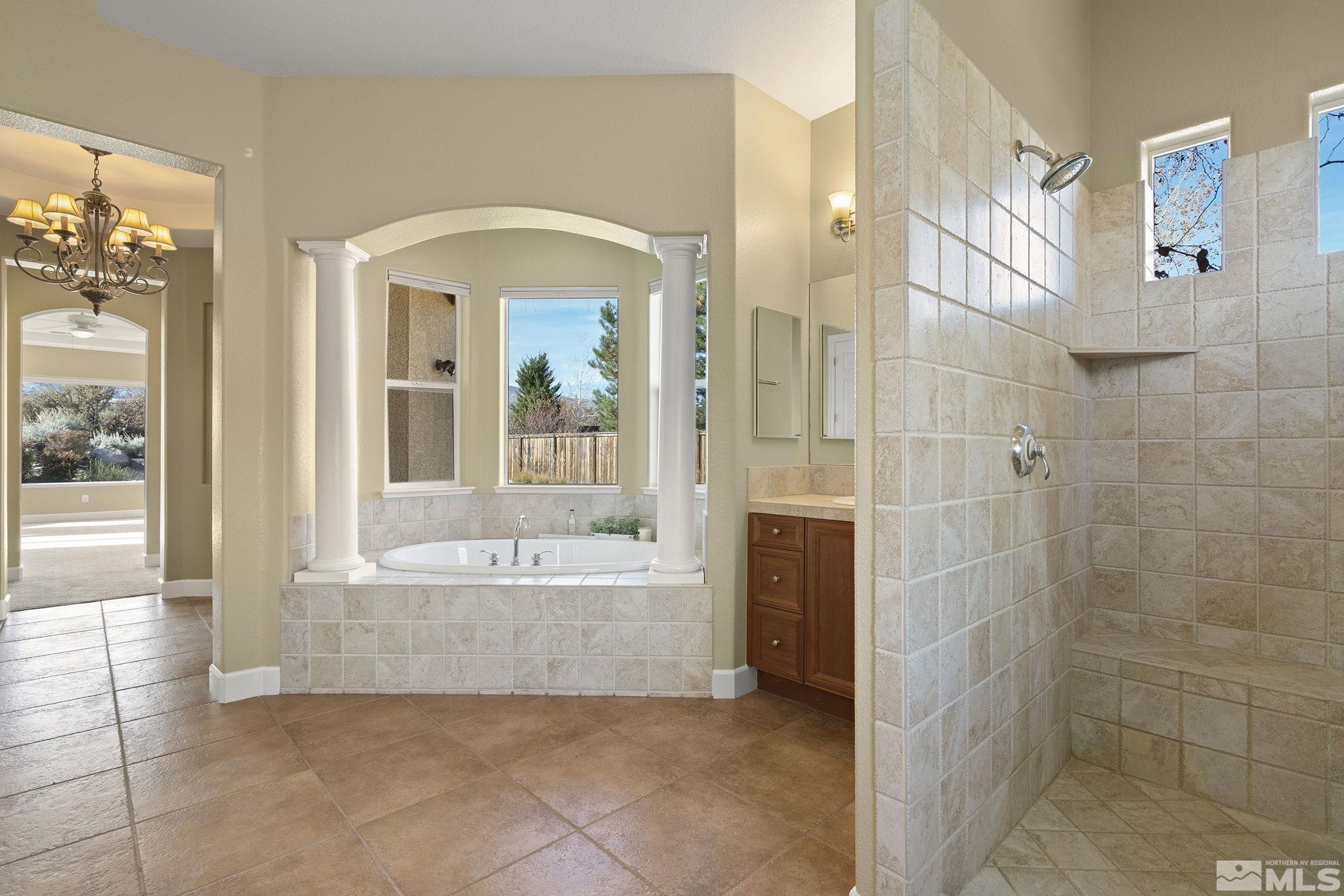 15300 Redmond Loop Reno, NV 89511 - Photo 21 of 38 a spacious bathroom with a bathtub and a shower
