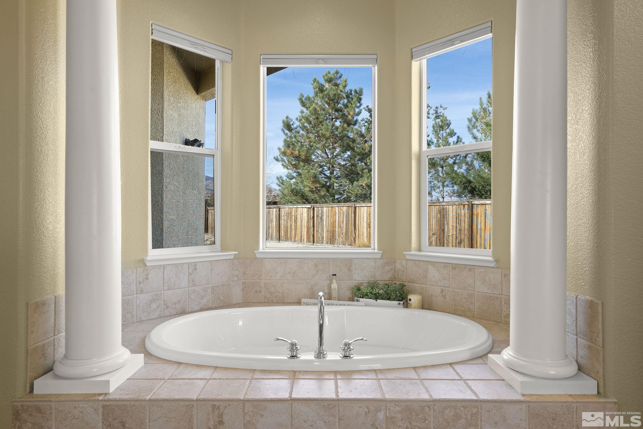 15300 Redmond Loop Reno, NV 89511 - Photo 22 of 38 a white bath tub sitting in a bathroom next to a window