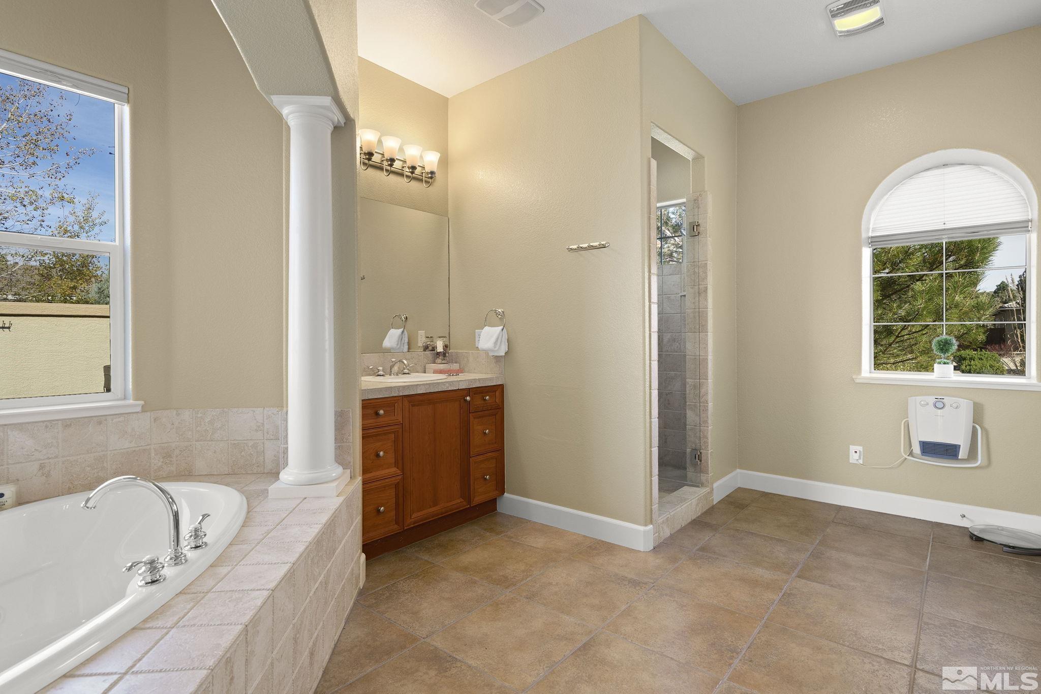 15300 Redmond Loop Reno, NV 89511 - Photo 23 of 38 a bathroom with a tub sink and mirror