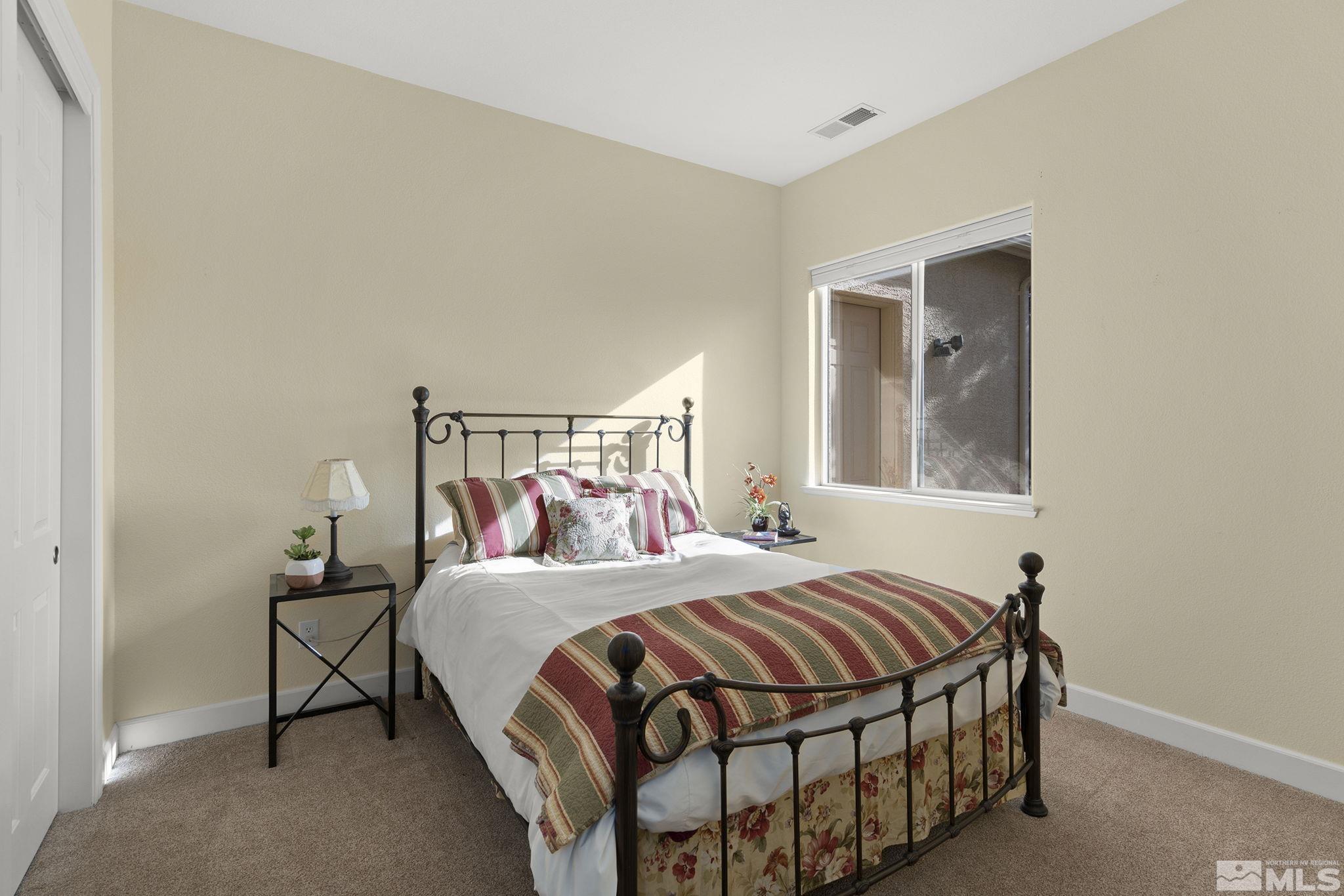 15300 Redmond Loop Reno, NV 89511 - Photo 28 of 38 a bedroom with a bed and window
