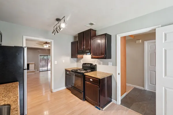 a kitchen with granite countertop stainless steel appliances and wooden cabinets