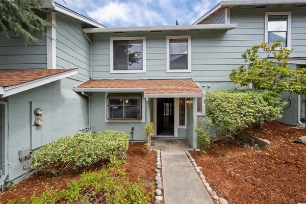 a front view of a house with garden