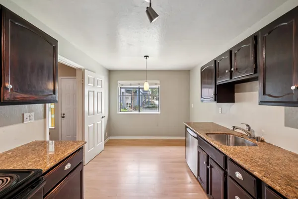 a bathroom with a granite countertop sink mirror and toilet