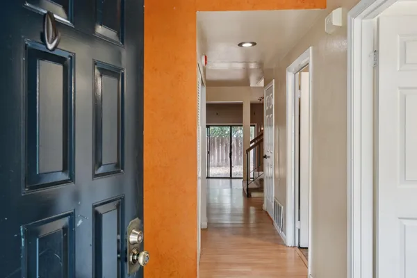 a view of entryway and hall with wooden floor
