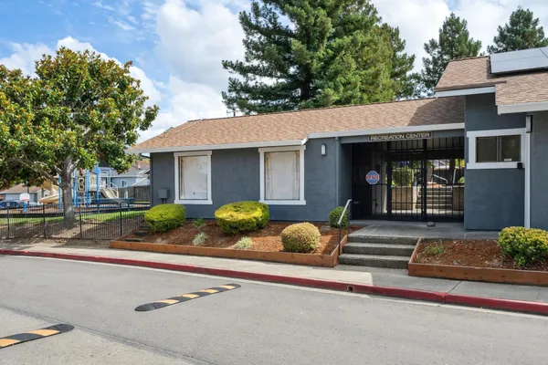 a view of a house with backyard and sitting area