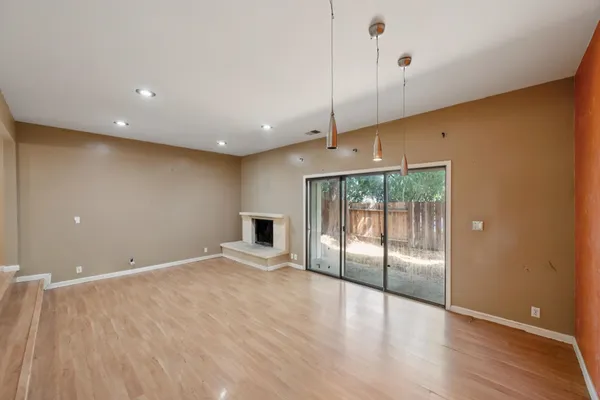 a view of backyard with wooden fence and large trees