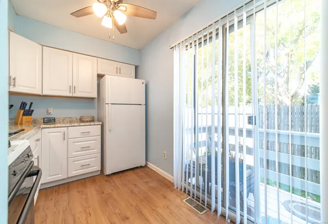 a kitchen with white cabinets and white appliances