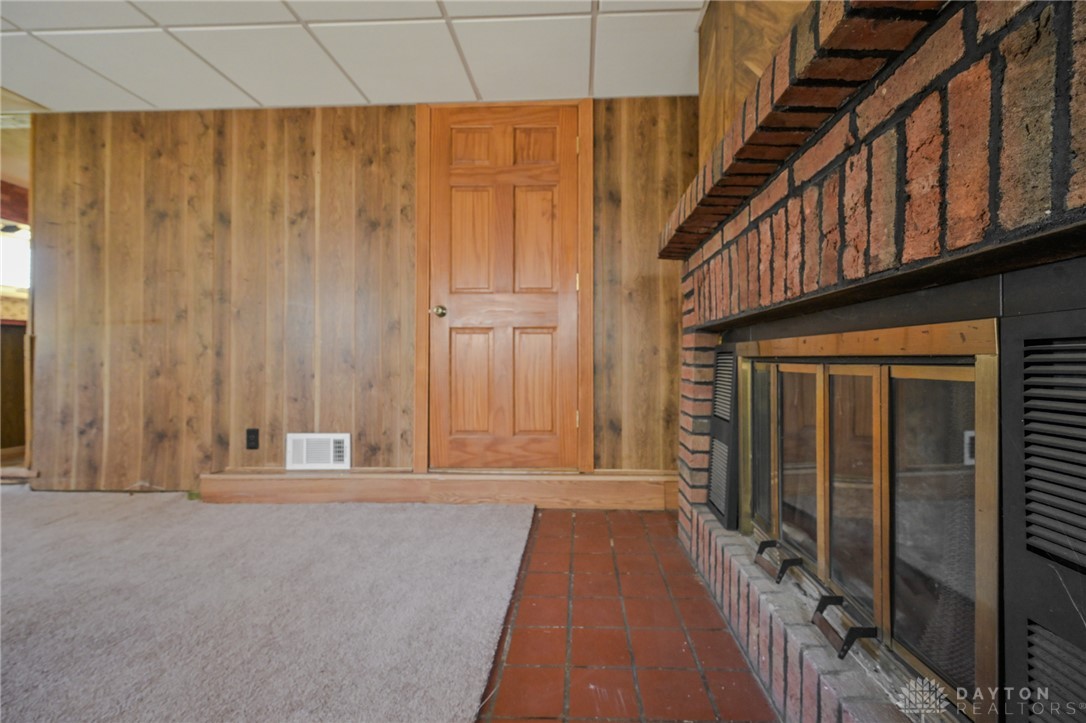 3057 Springfield Xenia Road Springfield, OH 45506 - Photo 26 of 37 This living area features a classic brick fireplace, creating a warm and inviting atmosphere.