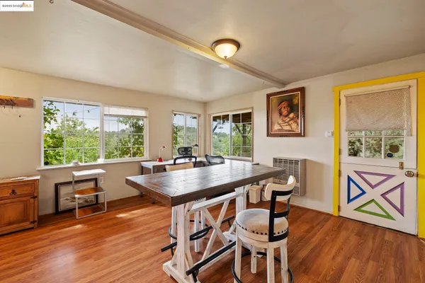 a dining room with furniture window and wooden floor