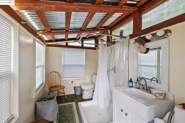 a bathroom with a sink mirror and toilet