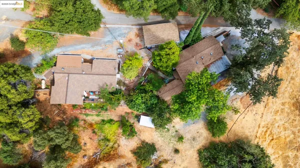 an aerial view of a house with a yard