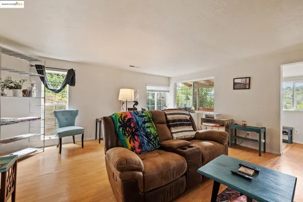 a living room with furniture and wooden floor