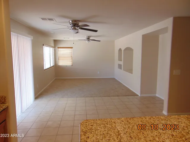 an empty room with a ceiling fan