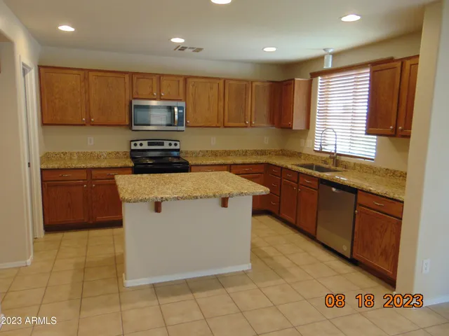 a kitchen with granite countertop a sink and a stove