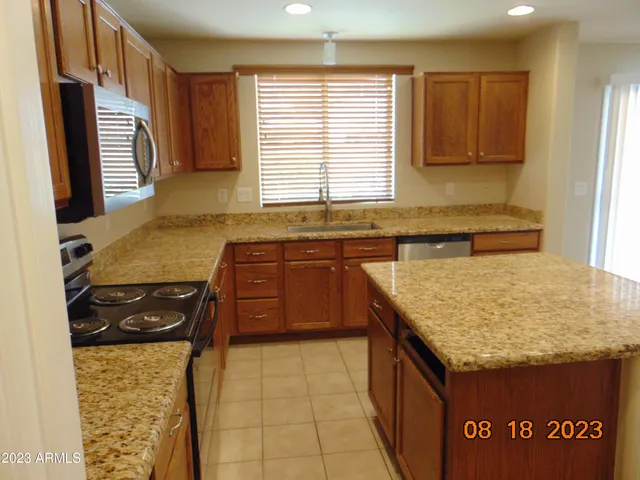 a stove top oven sitting inside of a kitchen