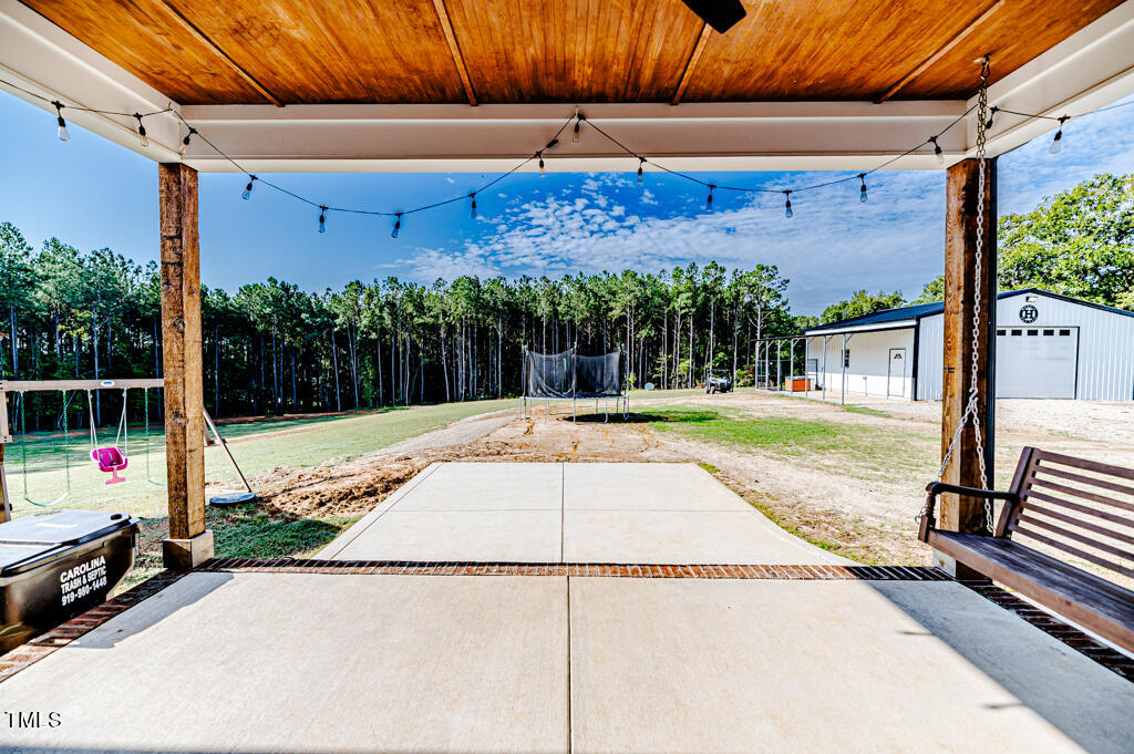 997 Jackson Road Fuquay-Varina, NC 27526 - Photo 12 of 75 a view of a backyard with a tv