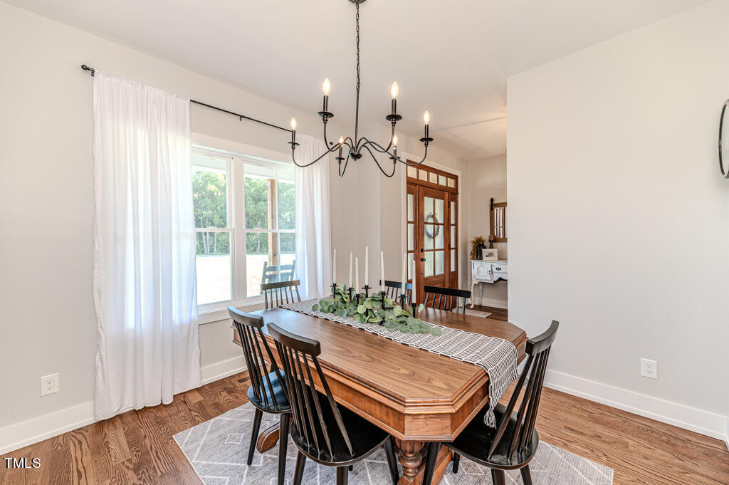 997 Jackson Road Fuquay-Varina, NC 27526 - Photo 16 of 75 a view of a dining room with furniture window and wooden floor