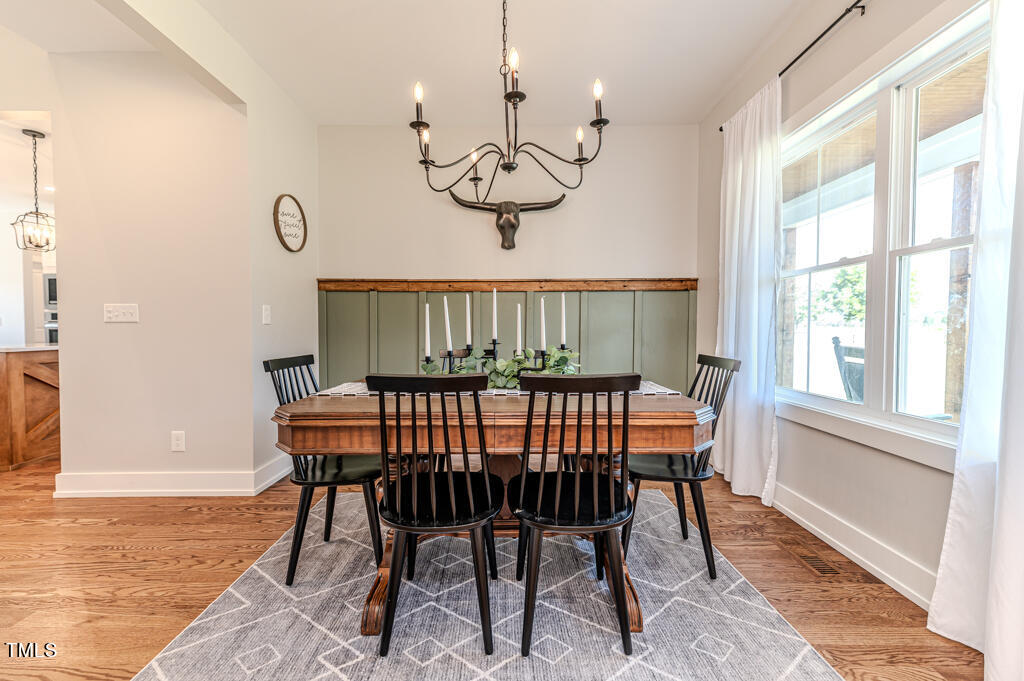 997 Jackson Road Fuquay-Varina, NC 27526 - Photo 18 of 75 a view of a dining room with furniture window and wooden floor
