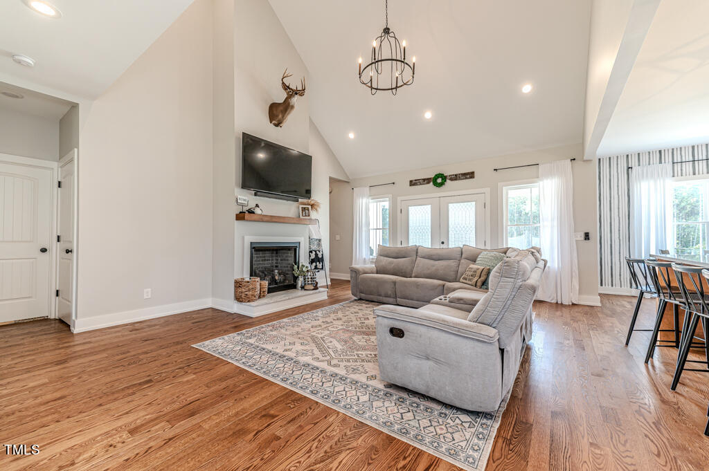997 Jackson Road Fuquay-Varina, NC 27526 - Photo 21 of 75 a living room with furniture wooden floor and a fireplace