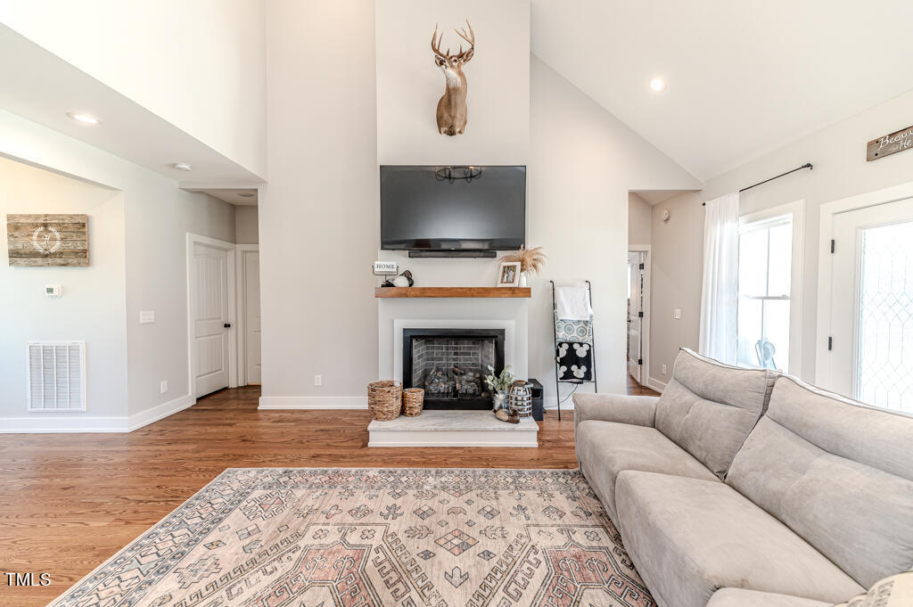997 Jackson Road Fuquay-Varina, NC 27526 - Photo 22 of 75 a living room with furniture and a fireplace