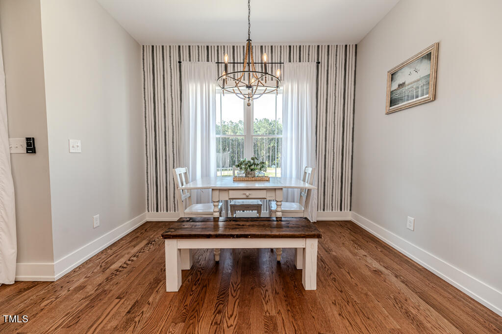997 Jackson Road Fuquay-Varina, NC 27526 - Photo 36 of 75 a dining room with wooden floor and a window