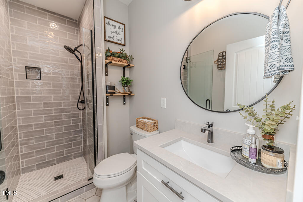 997 Jackson Road Fuquay-Varina, NC 27526 - Photo 44 of 75 a bathroom with a sink toilet and shower