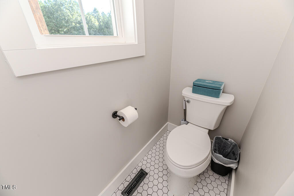 997 Jackson Road Fuquay-Varina, NC 27526 - Photo 54 of 75 a white toilet sitting next to a window