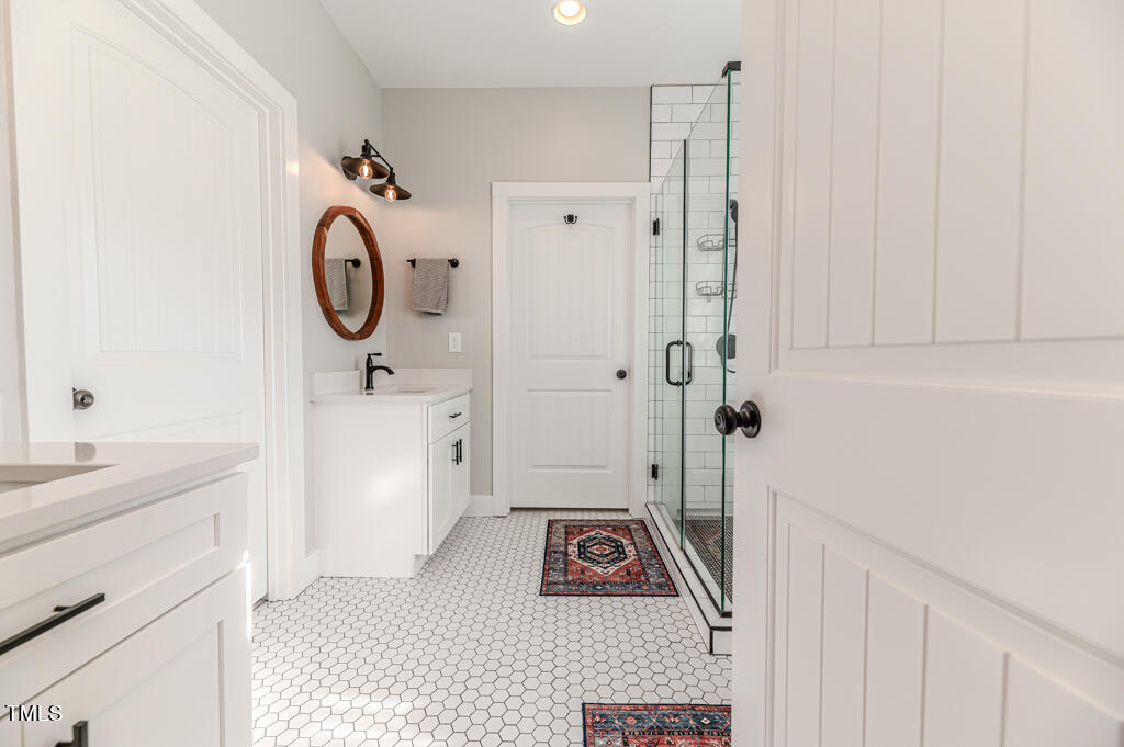 997 Jackson Road Fuquay-Varina, NC 27526 - Photo 55 of 75 a bathroom with a sink a toilet and shower
