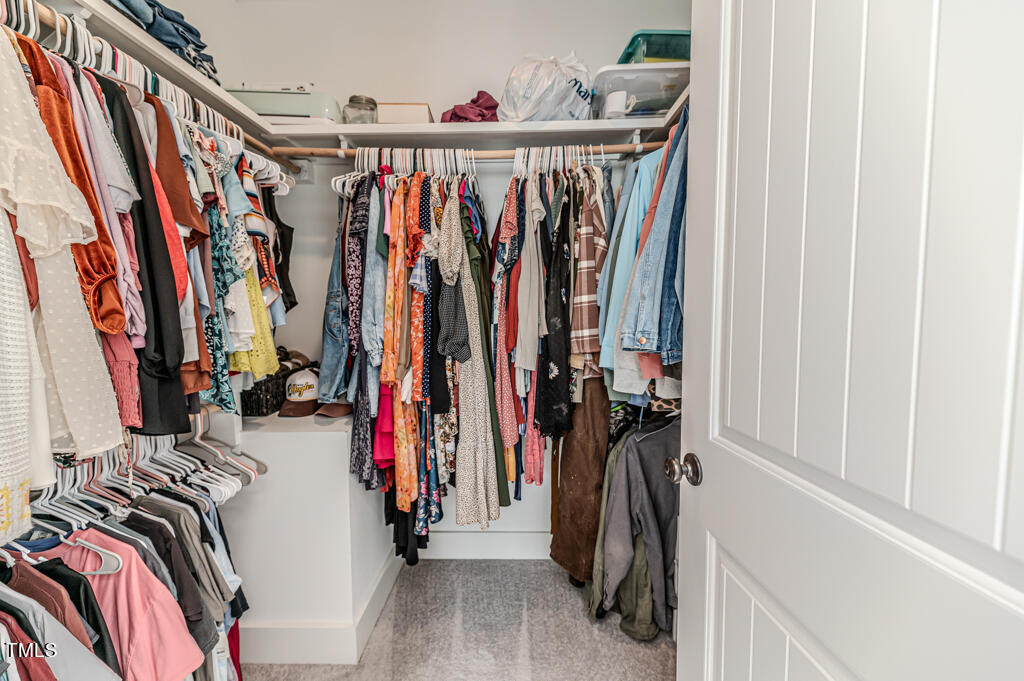 997 Jackson Road Fuquay-Varina, NC 27526 - Photo 56 of 75 a view of walk in closet with clothes