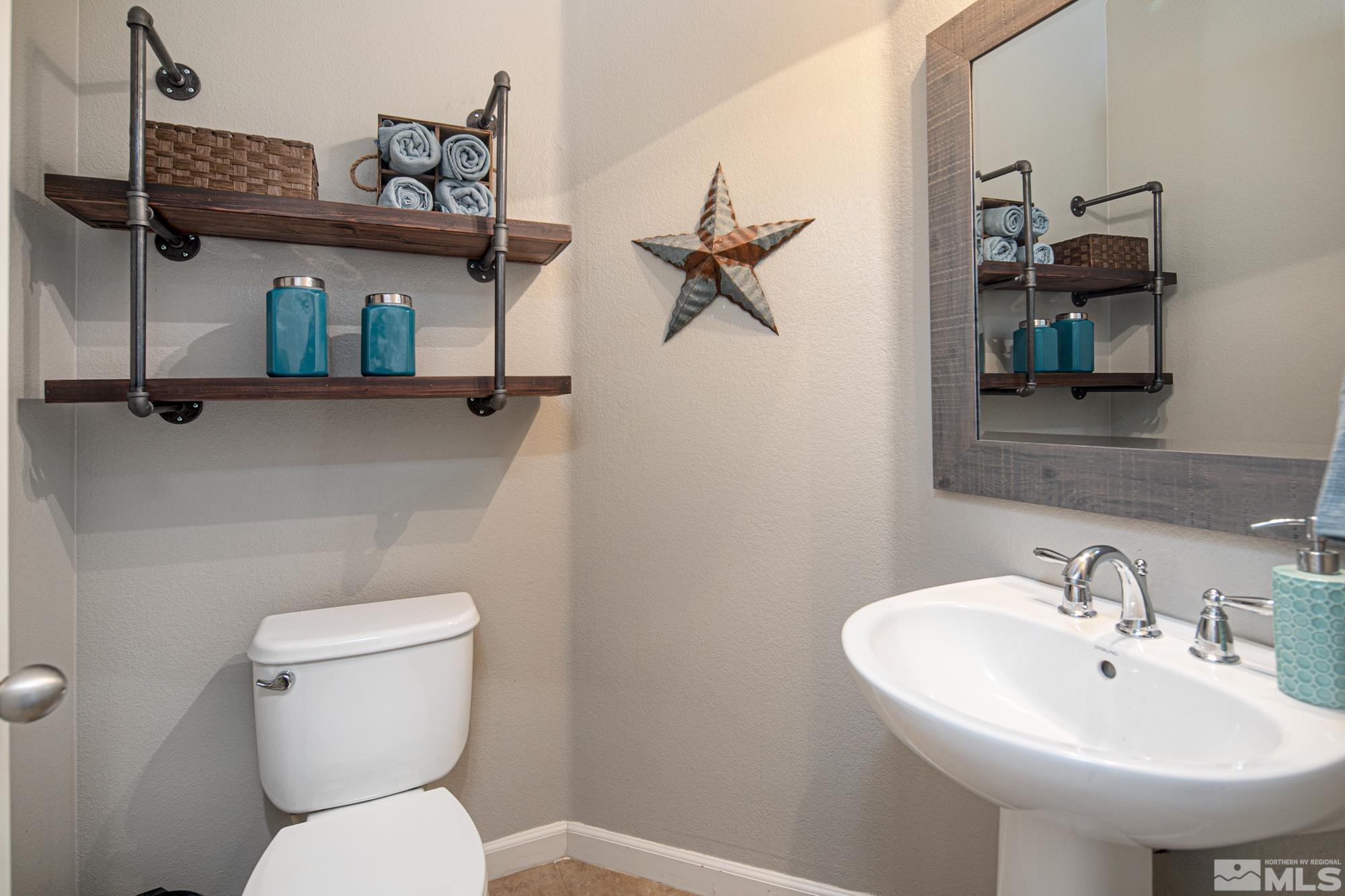 2093 Waterhouse Road Reno, NV 89521 - Photo 14 of 30 a bathroom with a toilet a sink and mirror