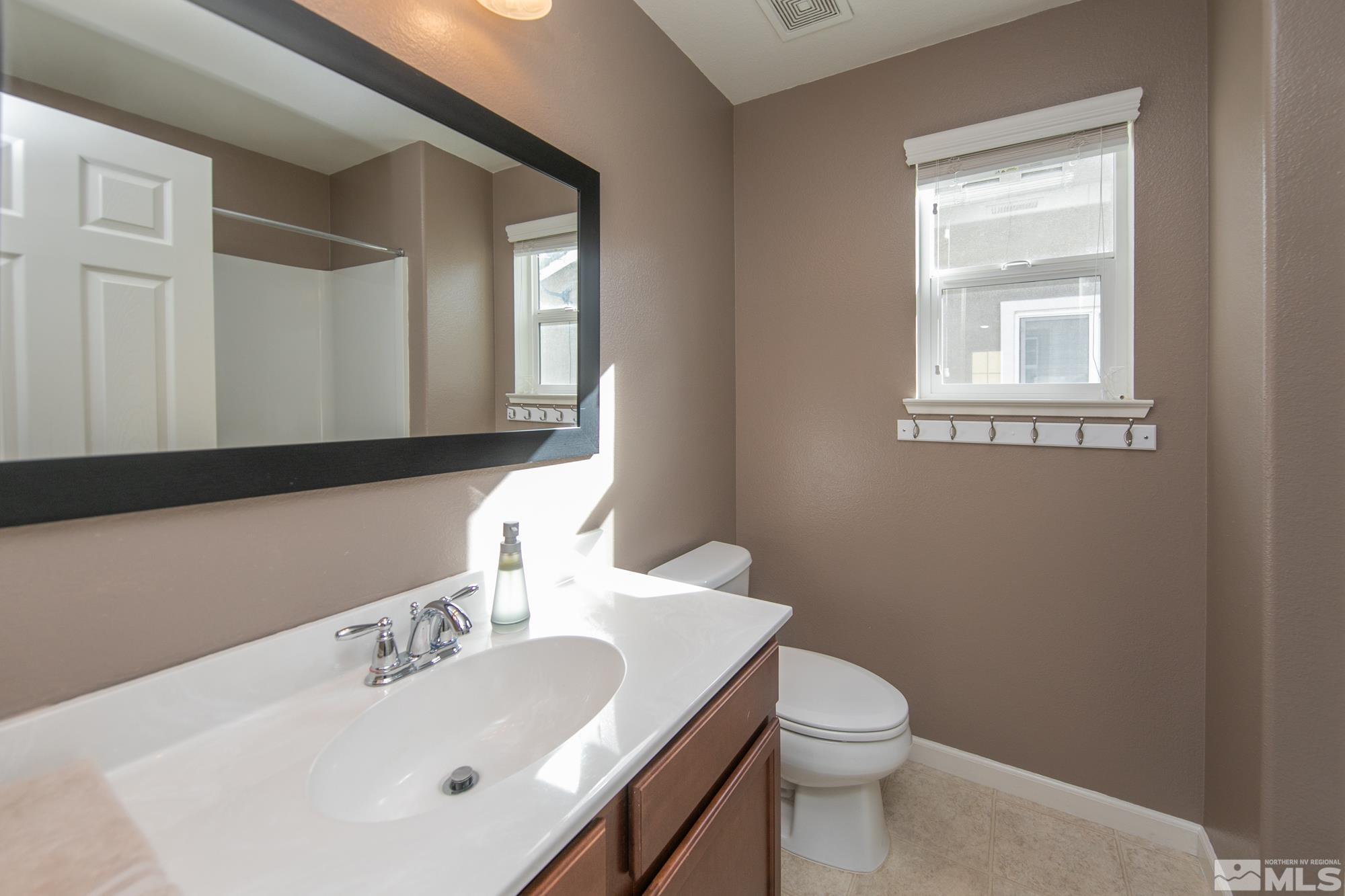 2093 Waterhouse Road Reno, NV 89521 - Photo 16 of 30 a bathroom with a toilet sink and mirror