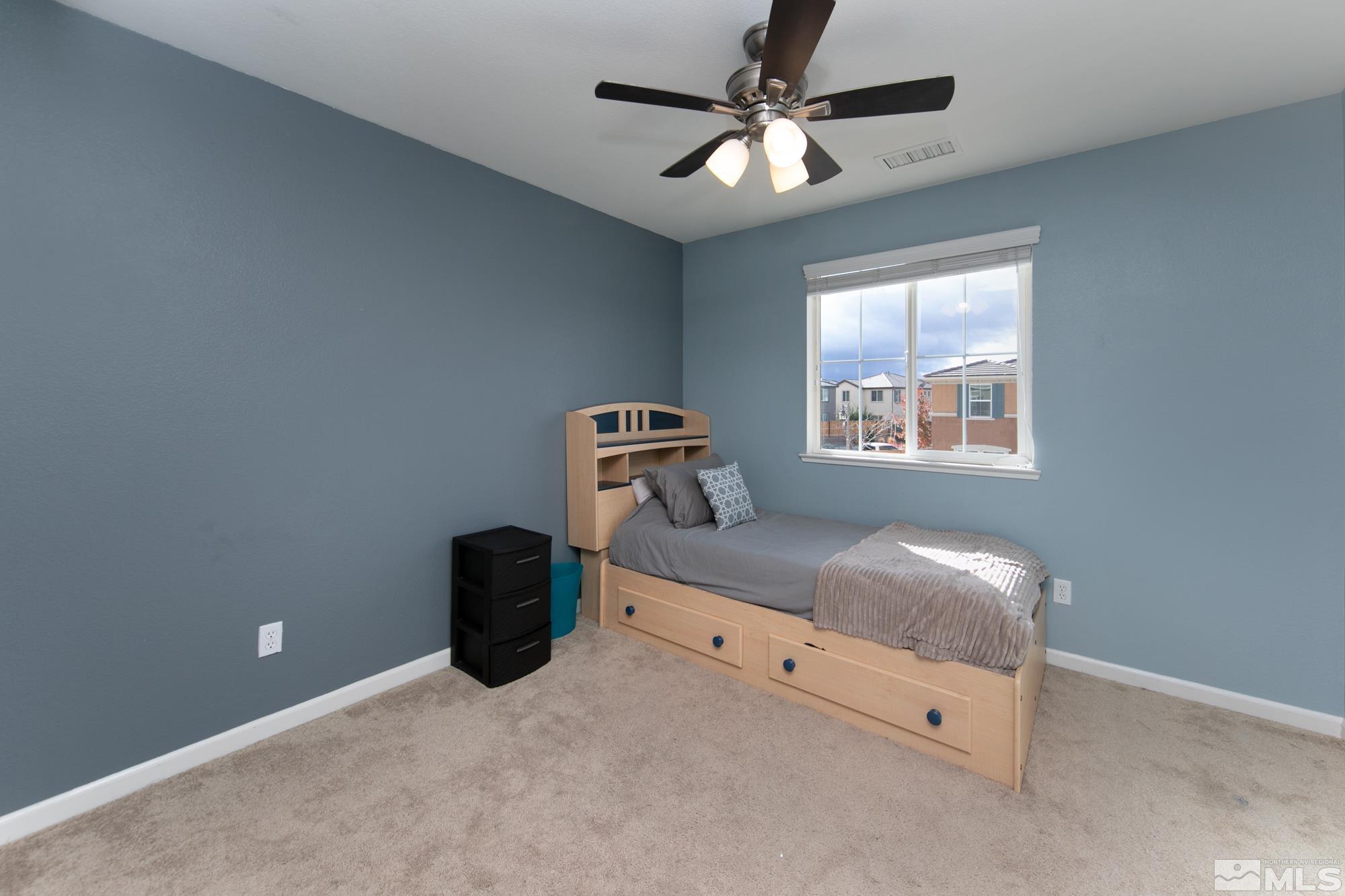 2093 Waterhouse Road Reno, NV 89521 - Photo 17 of 30 a bedroom with a bed and a chandelier