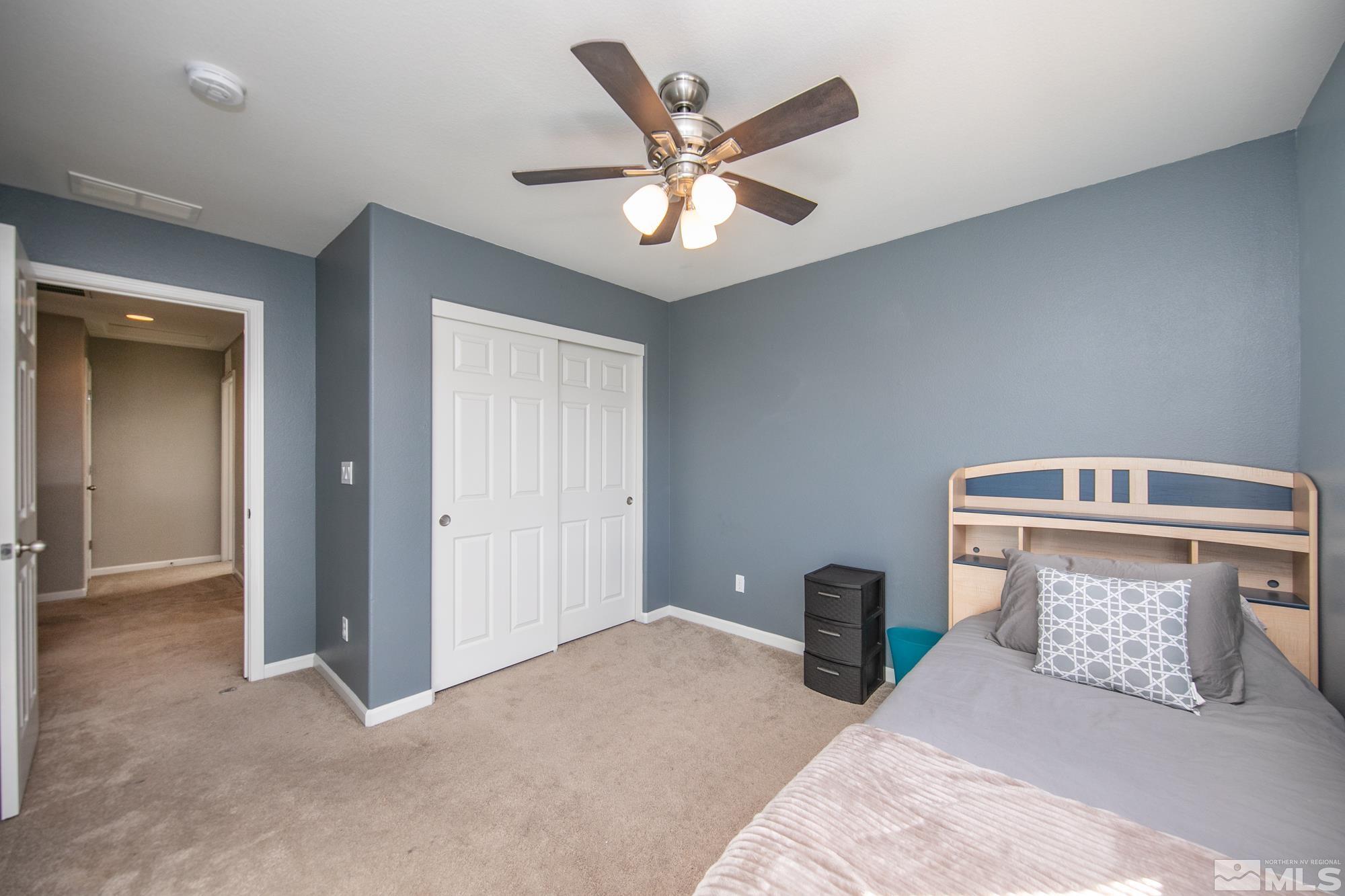 2093 Waterhouse Road Reno, NV 89521 - Photo 18 of 30 a bedroom with a bed and ceiling fan