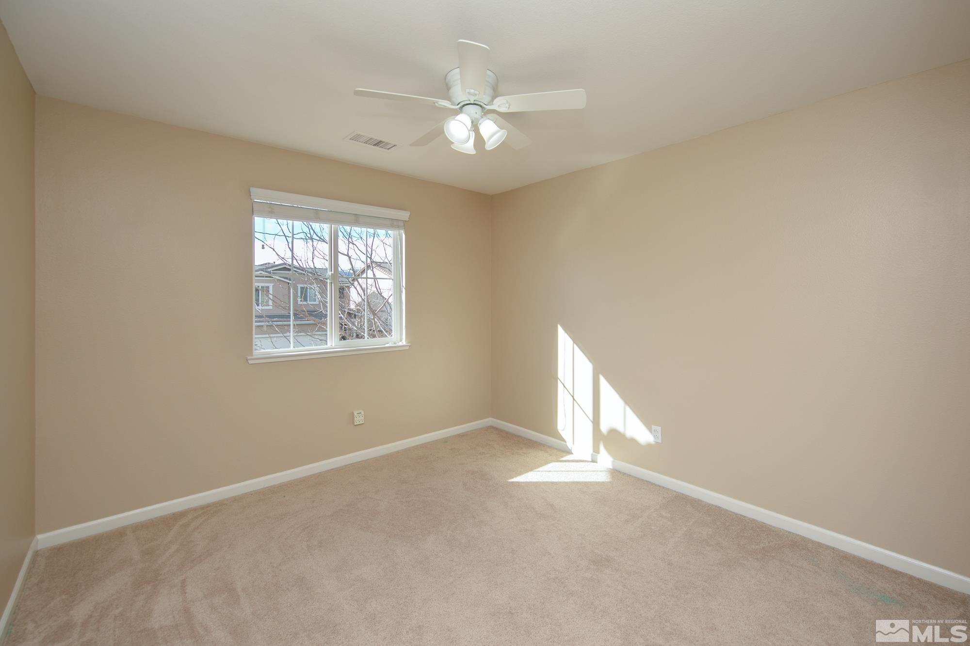 2093 Waterhouse Road Reno, NV 89521 - Photo 19 of 30 an empty room with a window and a ceiling fan