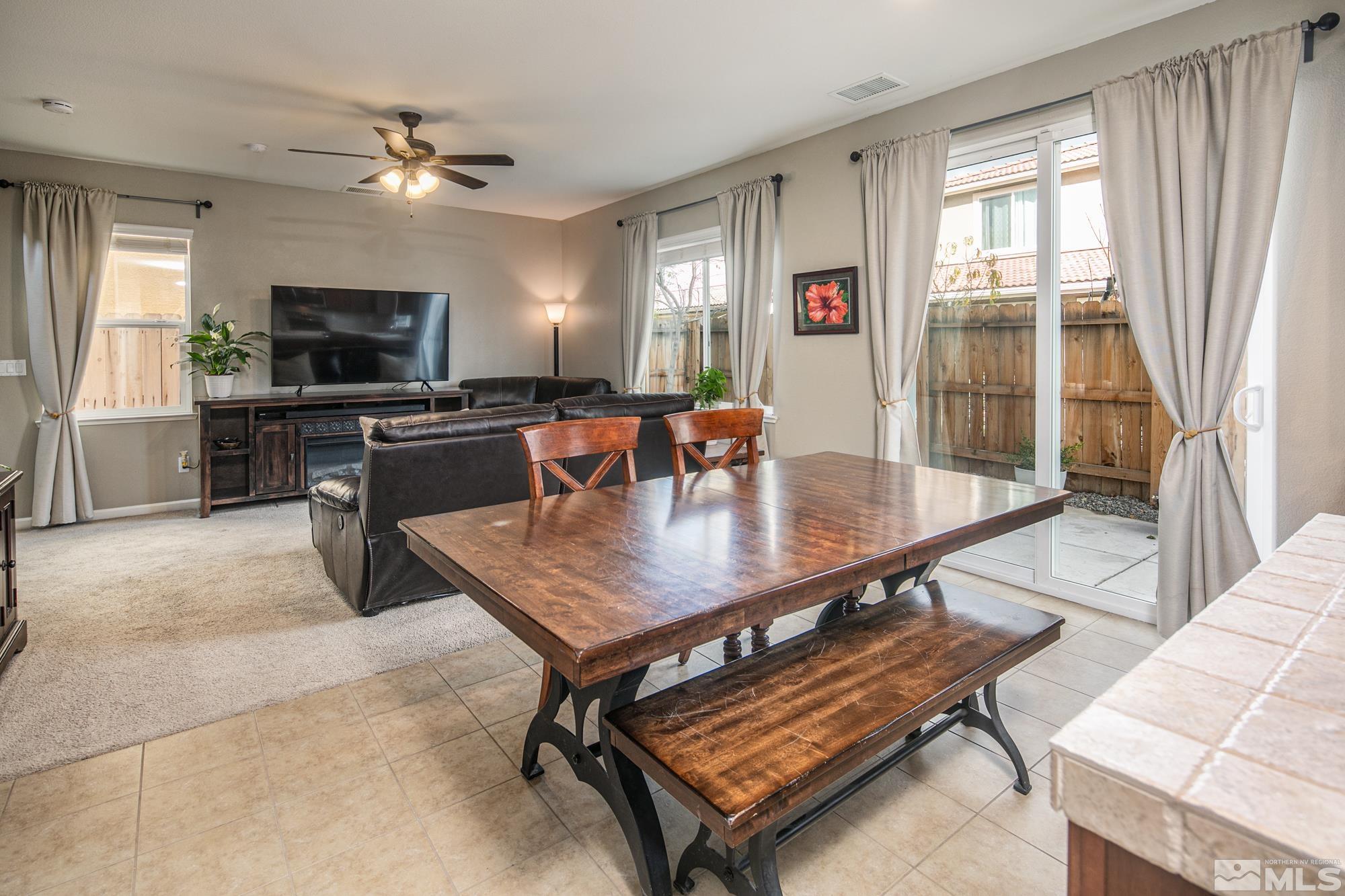 2093 Waterhouse Road Reno, NV 89521 - Photo 10 of 30 a dining room with wooden floor a glass table and chairs