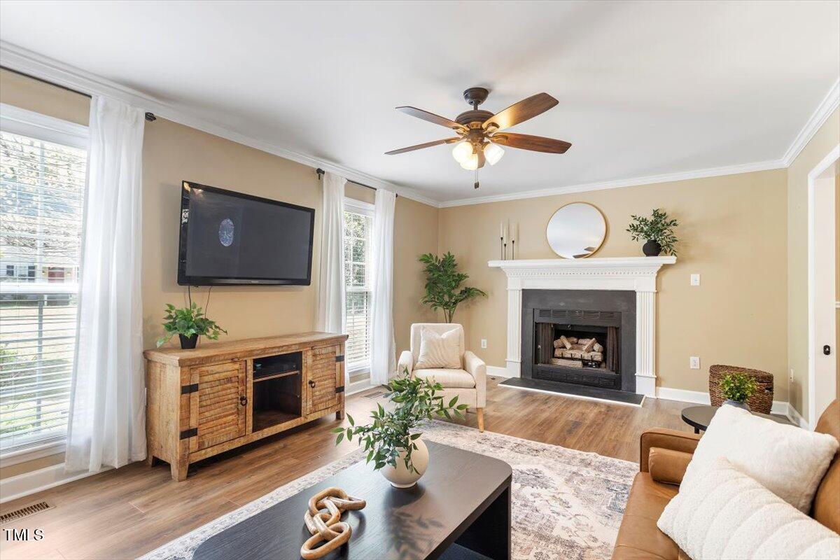 4725 Sinclair Drive Raleigh, NC 27616 - Photo 11 of 36 a living room with furniture a flat screen tv and a fireplace