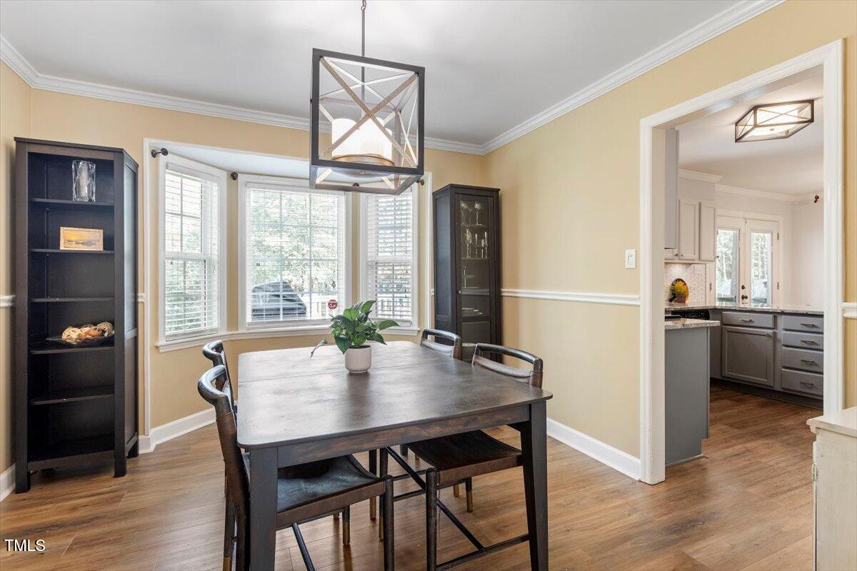 4725 Sinclair Drive Raleigh, NC 27616 - Photo 12 of 36 a view of a dining room with furniture window and wooden floor
