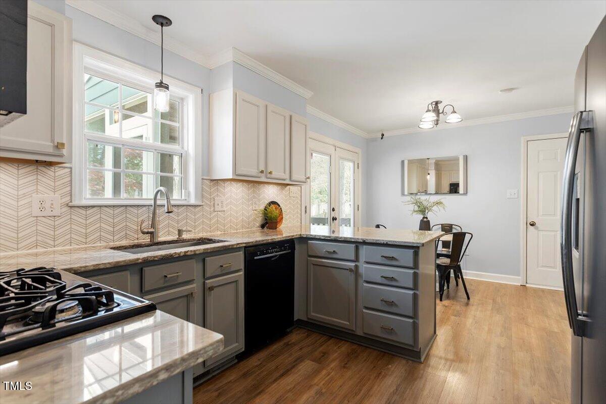 4725 Sinclair Drive Raleigh, NC 27616 - Photo 13 of 36 a kitchen with wooden floors and appliances