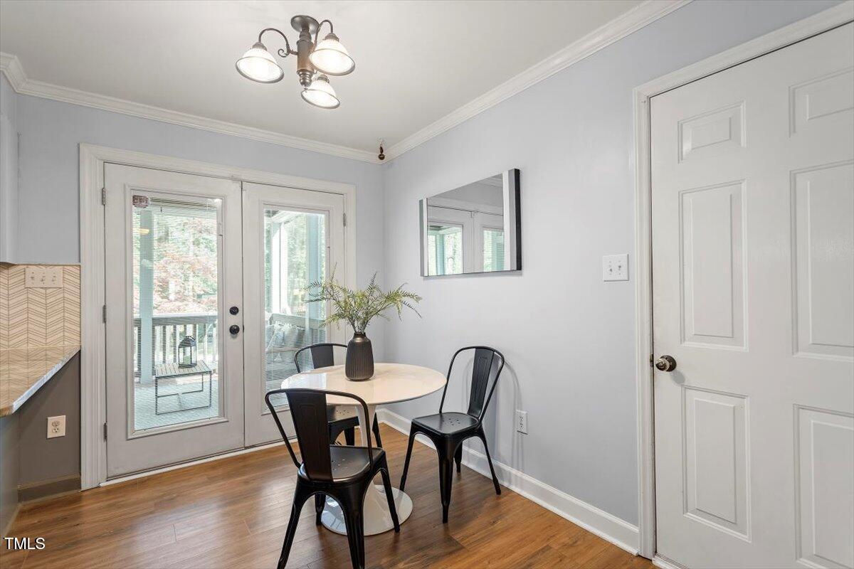 4725 Sinclair Drive Raleigh, NC 27616 - Photo 16 of 36 a view of a dining room with furniture window and wooden floor